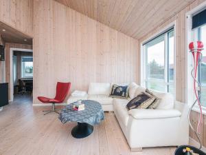 a living room with a white couch and a table at 4 star holiday home in Ulfborg in Fjand Gårde