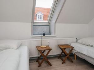 a room with two twin beds and a window at Charming Retreat in Ringkobing in Ringkøbing