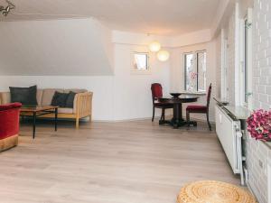 a living room with a table and chairs at Charming Retreat in Ringkobing in Ringkøbing