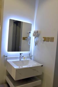 a bathroom with a sink and a large mirror at غيمة in Hail +28 photos