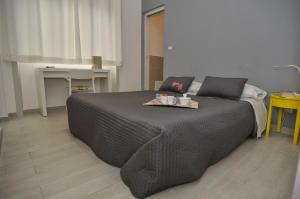 a bedroom with a large bed with a tray on it at Il Vicolo B&B in Milazzo