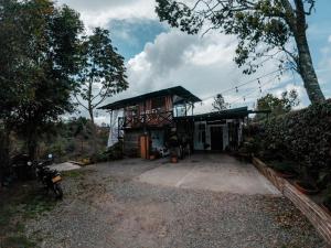 a house with a motorcycle parked in front of it at hotel boutique Almaia 17 cerca del aeropuerto jose m cordova in Rionegro