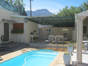 a house with a swimming pool and a patio at Ladismith Manor in Ladismith