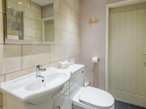 a white bathroom with a sink and a toilet at 2 Bed in Louth oc-86797 in Louth +8 photos