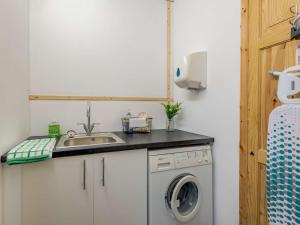 a kitchen with a sink and a washing machine at 2 Bed in Louth oc-86797 in Louth