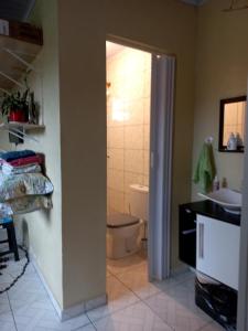 a bathroom with a toilet and a sink at Studio Funcional in Guaraqueçaba