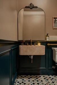 a bathroom with a sink and a mirror at MarQueen Hotel - NEWLY RENOVATED in Seattle +54 photos