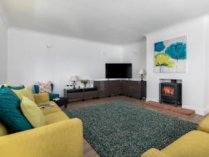 a living room with a couch and a fireplace at 4 Bed in Cromer oc-81469 in West Runton