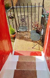 a stairway with two chairs and a fence at Cosy Seaside Snug in Helensburgh