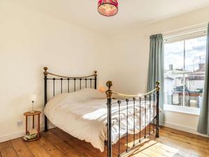 a bedroom with a bed and a window at 3 Bed in Holt oc-87147 in Holt