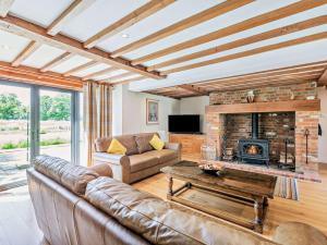a living room with a couch and a fireplace at 5 Bed in Ashford oc-76428 in Smarden