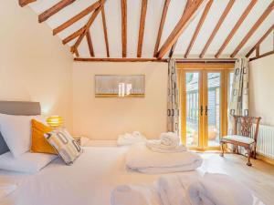 a room with a large white bed and a chair at 5 Bed in Ashford oc-76428 in Smarden +45 photos