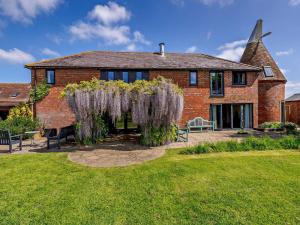 a brick house with wisteria hanging from it at 5 Bed in Ashford oc-76428 in Smarden