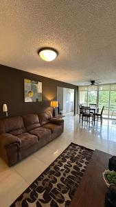 a living room with a couch and a dining room at Jaco Beach Penthouse in Jacó