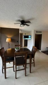 a dining room with a ceiling fan and a table and chairs at Jaco Beach Penthouse in Jacó +23 photos