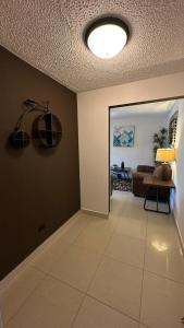 a living room with a couch and a ceiling at Jaco Beach Penthouse in Jacó