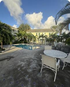 a patio with a table and chairs next to a pool at The Palms apt 1 in Cedar Grove