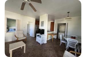 a living room with a table and chairs and a kitchen at The Palms apt 1 in Cedar Grove