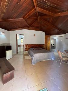 a large bedroom with a bed and a table at Apoena in Conde
