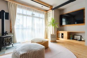 a living room with a large window and a tv at Cellar 88 in Sonogi