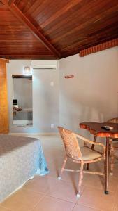a bedroom with a bed and a table and a chair at Apoena in Conde +4 photos