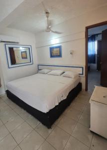 a bedroom with a large bed in a room at Acapulco LUUM hotel in Acapulco