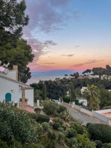 a view of a road with a sunset in the background at Seren Casa Begur - Illa Roja Beach in Begur