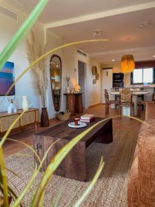 a living room with a couch and a table at Seren Casa Begur - Illa Roja Beach in Begur