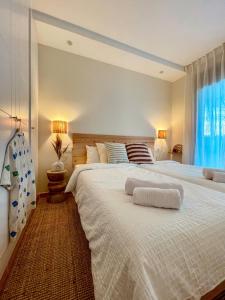 a bedroom with a large white bed with a window at Seren Casa Begur - Illa Roja Beach in Begur +26 photos