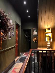 a hallway with a table with a lamp on it at The Goose Garden in Hebden Bridge +15 photos