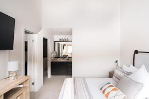 a white bedroom with a bed and a mirror at Lakefront Keystone Escape - Near Slopes & Trails in Keystone