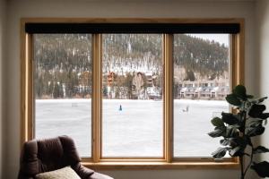 a window with a view of a snow covered field at Lakefront Keystone Escape - Near Slopes & Trails in Keystone +23 photos