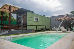 a swimming pool in a yard with a building at Refugio Lagunas in San Antonio