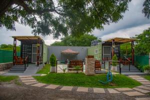 a house with a yard with a playground at Refugio Lagunas in San Antonio