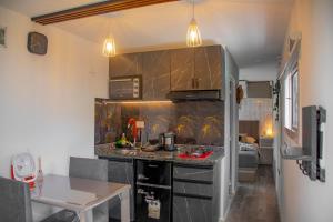 a kitchen with a counter and a table in a room at Refugio Lagunas in San Antonio