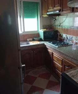 a kitchen with a sink and a stove top oven at Maison zakaria in Meknès