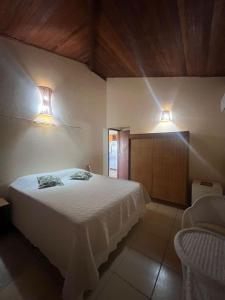a bedroom with a bed and two lights on the wall at Apoena in Conde