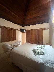 a bedroom with a large bed with a wooden ceiling at Apoena in Conde
