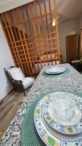a table with two plates on top of it at Kitinet Cunha in Cunha
