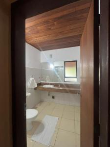 a bathroom with a toilet and a sink at Apoena in Conde