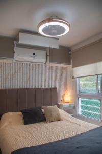 a bedroom with a large bed and a large window at Refugio Lagunas in San Antonio +45 photos