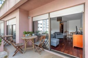 a living room with sliding glass doors and a dining room at Lisbon at Home in Lisbon