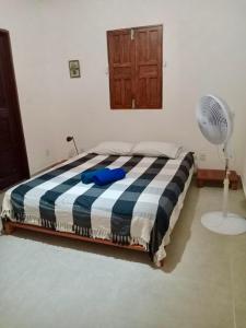 a bedroom with a bed and a fan at Relax Private Room - Santo André, BA in Santo André