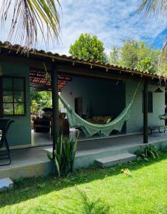 a hammock hanging from the side of a house at Relax Private Room - Santo André, BA in Santo André