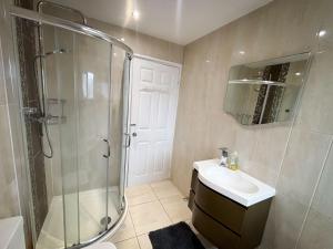 a bathroom with a shower and a sink at 6 Bed home near to Birmingham Nec Airport 6 miles from city centre in Marston Green +23 photos