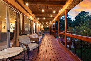 a porch with chairs and tables on a balcony at Airy Alto Escape Deck Games Views in Sun Valley