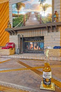 a bottle of corona beer sitting in front of a fireplace at Airy Alto Escape Deck Games Views in Sun Valley