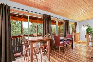 a dining room with a table and chairs on a balcony at Airy Alto Escape Deck Games Views in Sun Valley +57 photos
