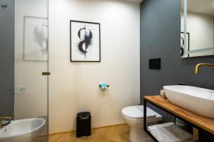 a bathroom with a sink and a toilet at Barberini Design Suites in Rome +31 photos