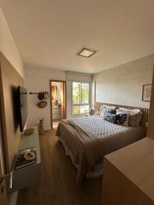 a bedroom with a bed and a television in it at Apartamento Garden in Baixio +29 photos